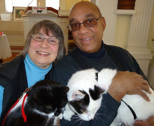 happy pet with foster man and woman